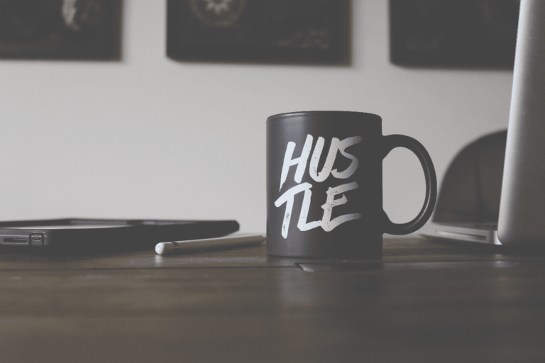 how to start a side hustle. A photo of a coffee mug that says Hustle